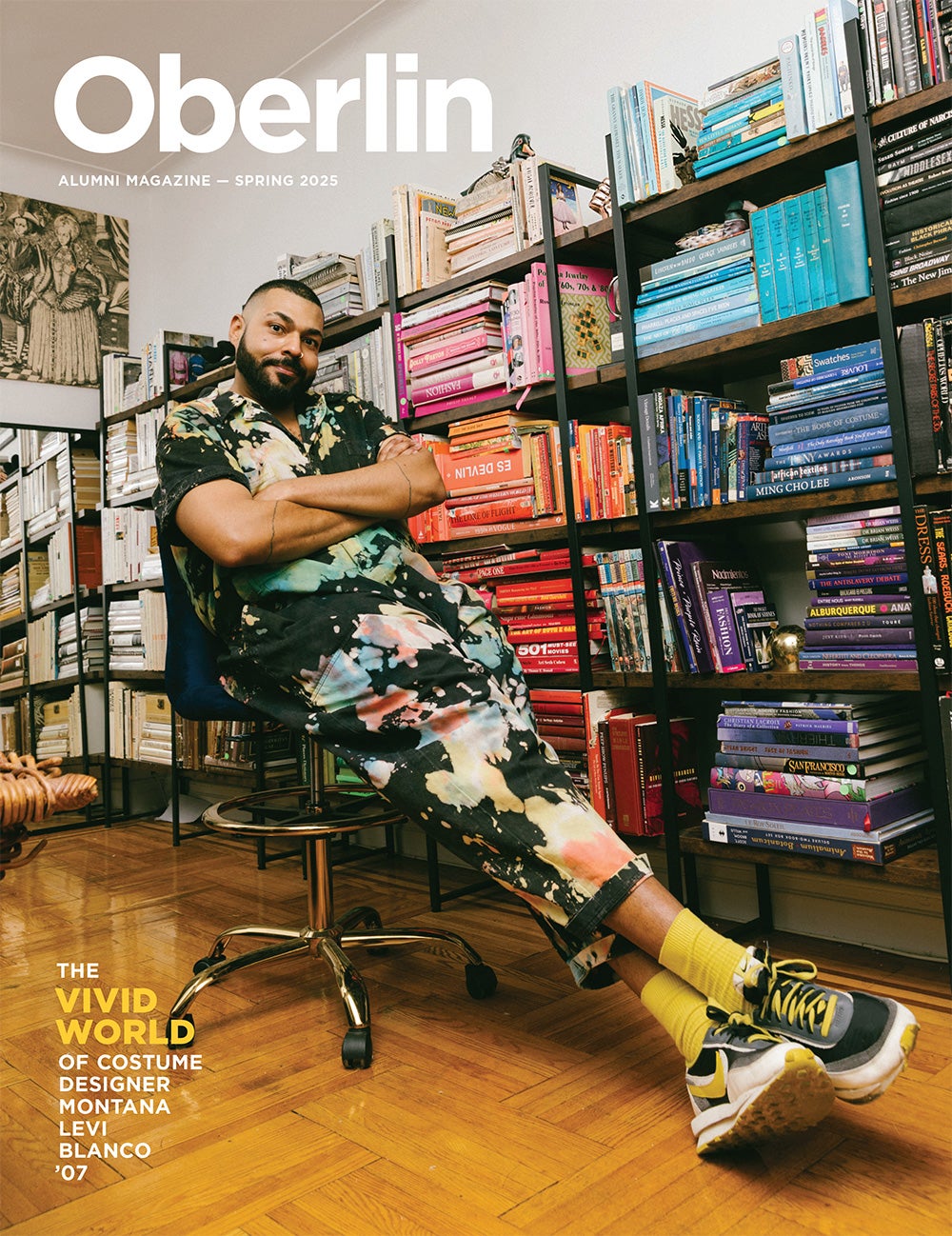 a person sitting with arms crossed next to a bookshelf