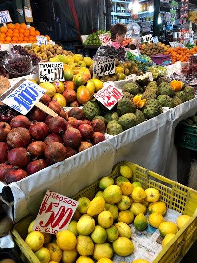 stacks of colorful fruit at a market stall
