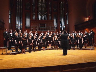 choir members on stage singing. photo.