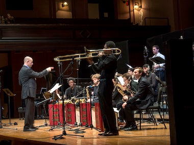 director leads student jazz performance. photo.