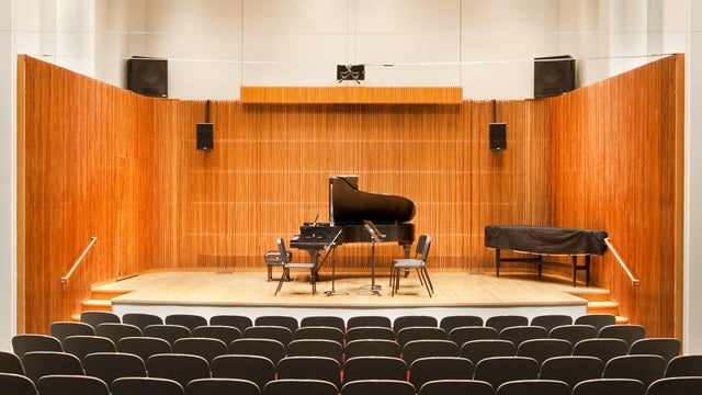 Piano on stage in an intimate hall