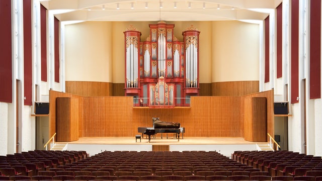 Large stage with grand piano and pipe organ