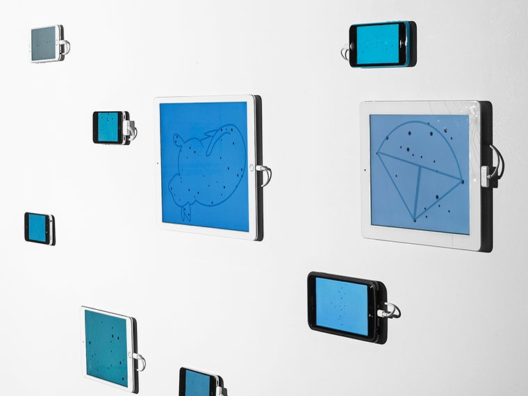 A gallery display of iPhones and iPads showing retired star constellations.
