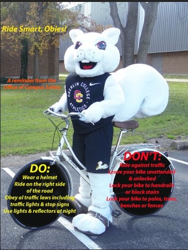 Yeobie astride a bicycle with safety messages on the wheels