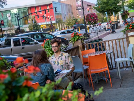 People seated at an outdoor cafe.