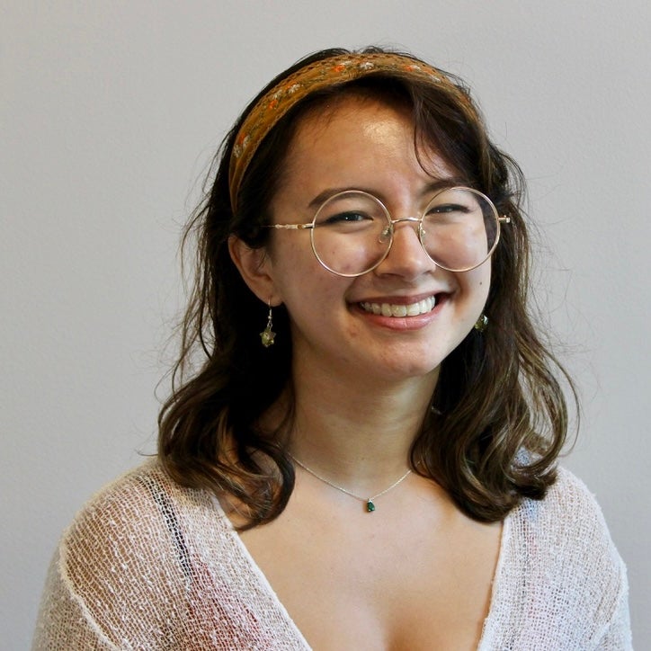 A female-identifying student with shoulder-length brown hair and a brown headband.