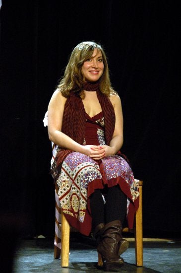 Elisa seated on stage