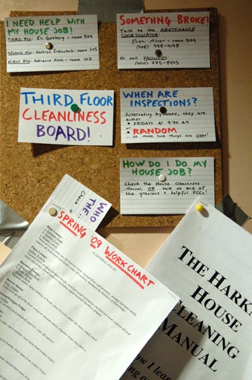 A corkboard full of flash cards with cleaning instructions