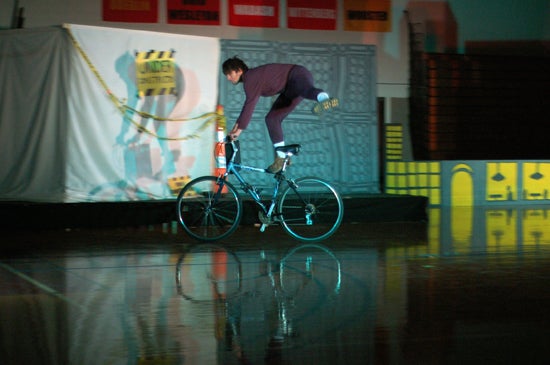A performer doing tricks on a bike
