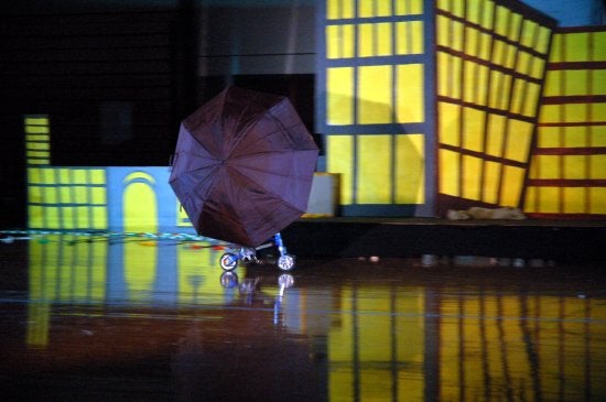 An umbrella completely shields a biker 