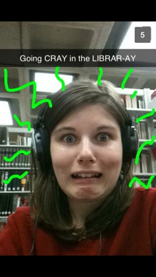 Snapchat selfie with the caption "going CRAY in the LIBRARY-AY"