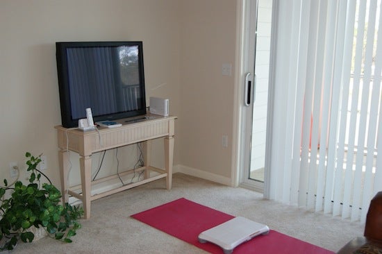 A yoga mat with a Wii Fit board in front of a TV