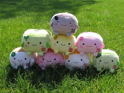 Tofu character plush toys stacked in a pyramid