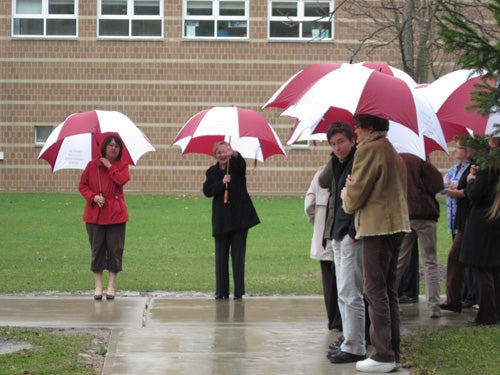 A crowd holds umbrellas in the rain 