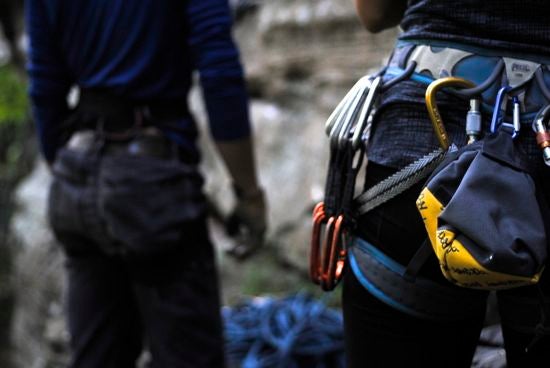 Carabiners hanging from the waist of a rock-climber