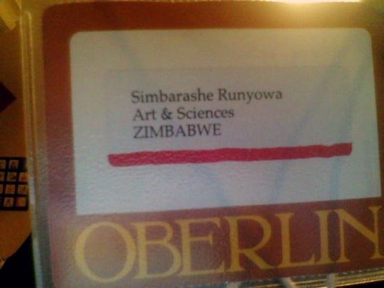 A name tag with the Oberlin logo has a label: Simbarashe Runyowa, Arts & Sciences, Zimbabwe