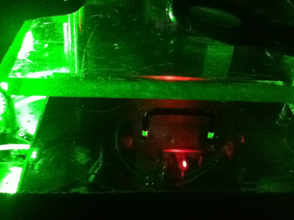 A green glow surrounds a red light. 