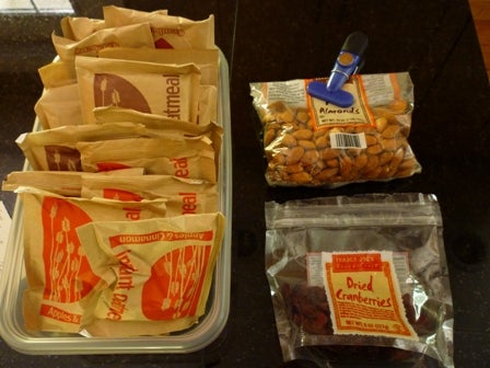 Lots of oatmeal packets, a bag of almonds, and a package of dried cranberries.