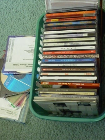 Music CDs spilling out of an overfilled basket