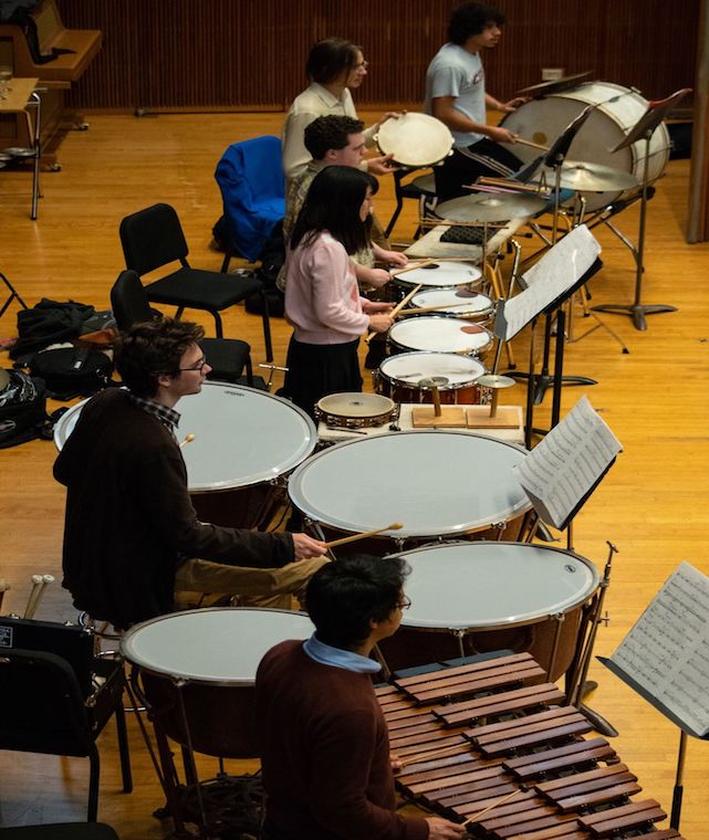 A photo of percussionists playing instruments.