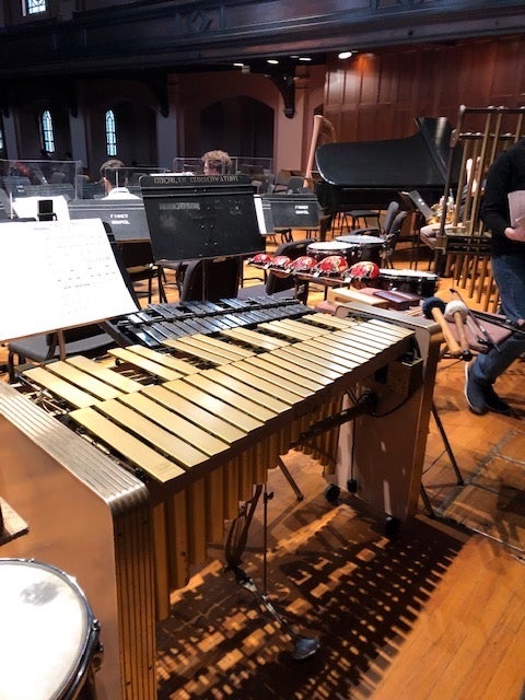 A vibraphone and other small percussion instruments on a stage.