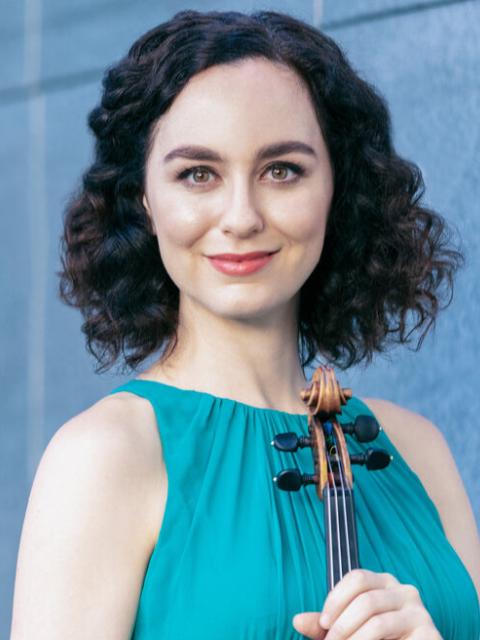 woman with dark hair and blue dress holding a violin