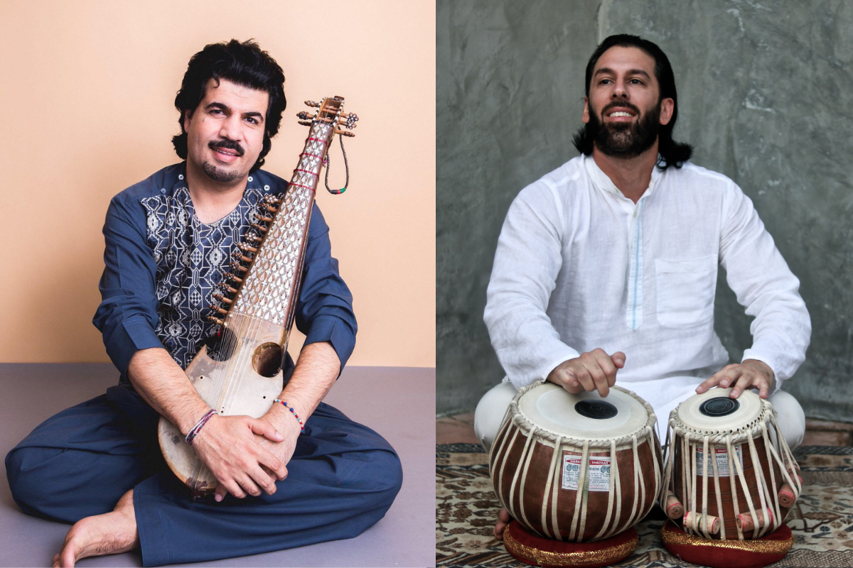 two men sitting, holding instruments