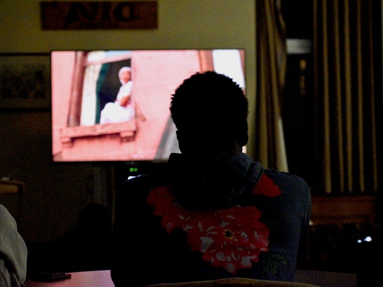 A student watches a movie on television.