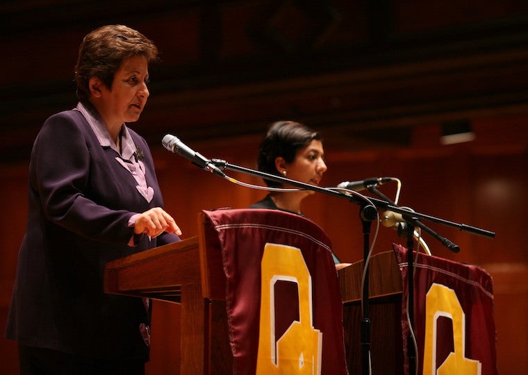 Two women speak at a podium