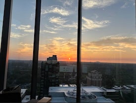 Sunset outside skyscraper window.