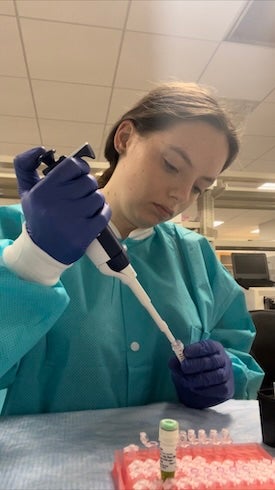 Woman uses scientific instrument. 