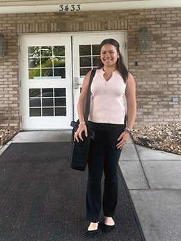 Woman stands in front of door