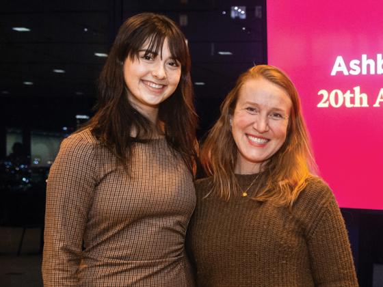 two people standing together at a business reception