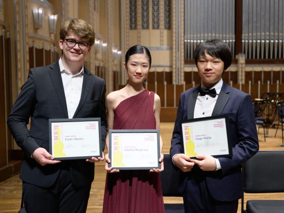 three young people pose for a photo with their Cooper award certificates