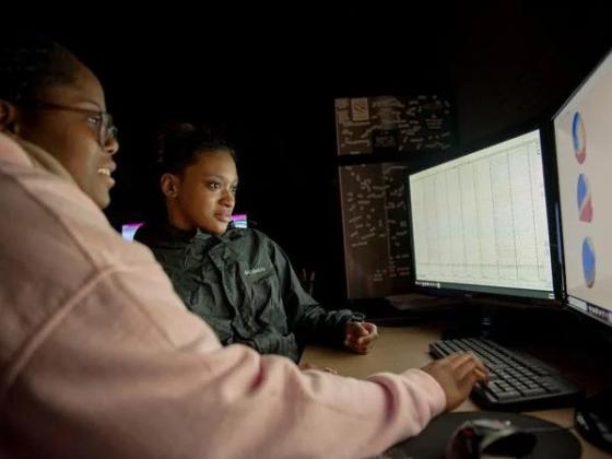 Students working together on a lab computer.