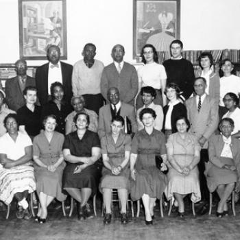 A group of two dozen people, many of them black and some white. Circa 1960.