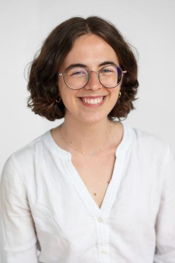 Ilana wearing a white shirt smiling.