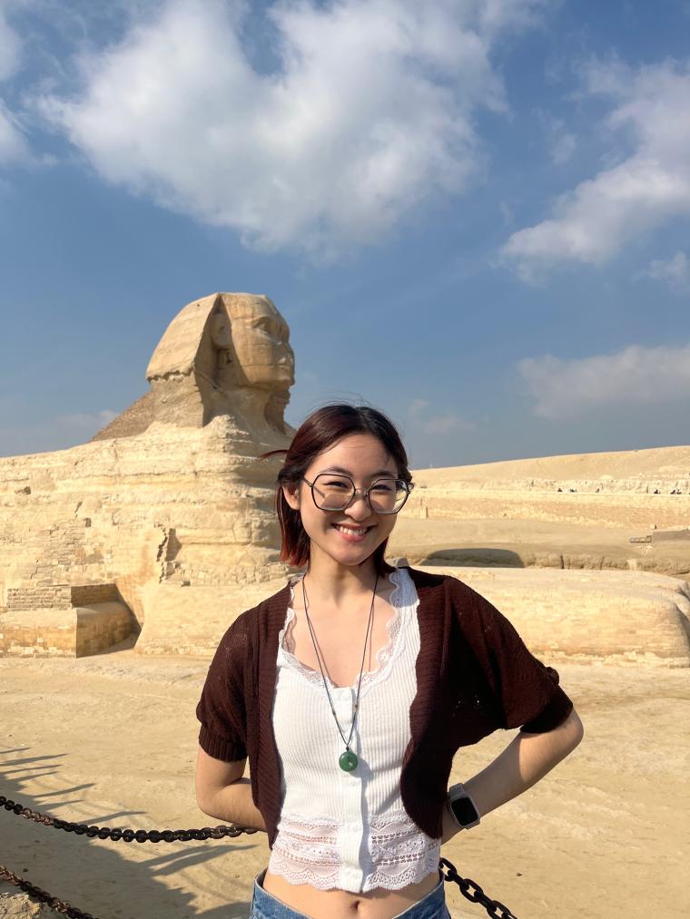 An Oberlin student in front of the Sphinx.