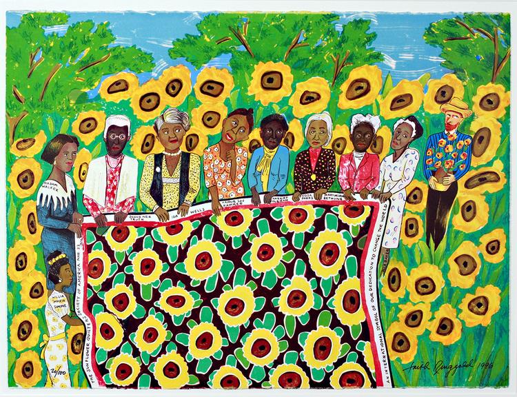 A group of women holding a sunflower patterned quilt.