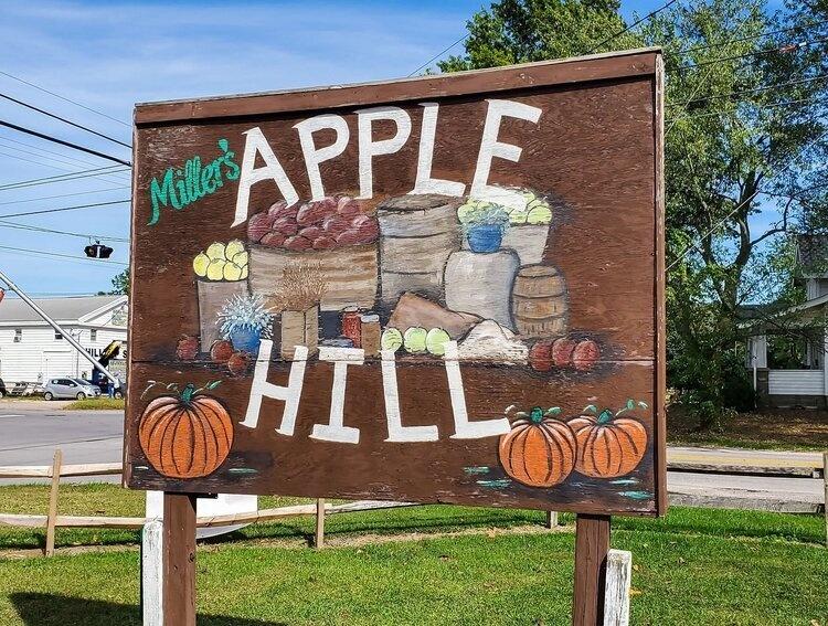 Painted wooden sign for Miller's Apple Hill Orchard