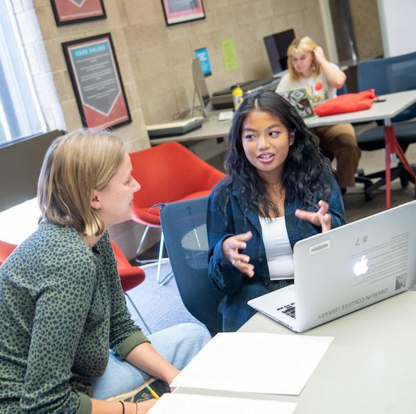 Students at table looking at computer