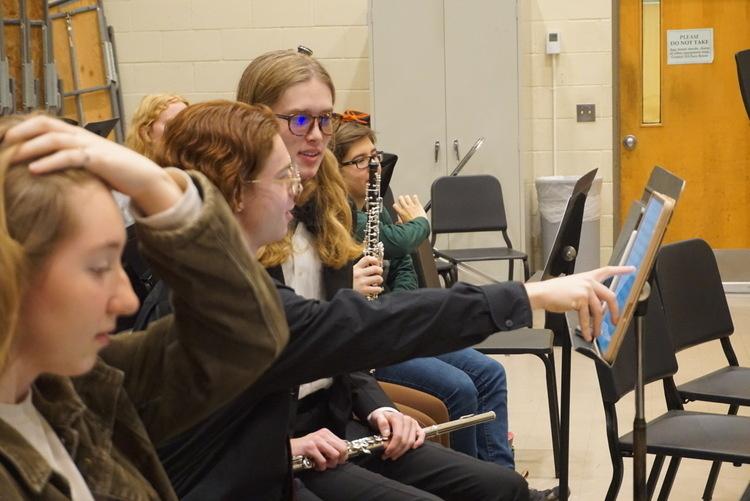 Students looking at music stands