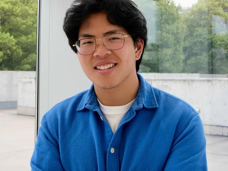 a smiling person wearing a blue shirt