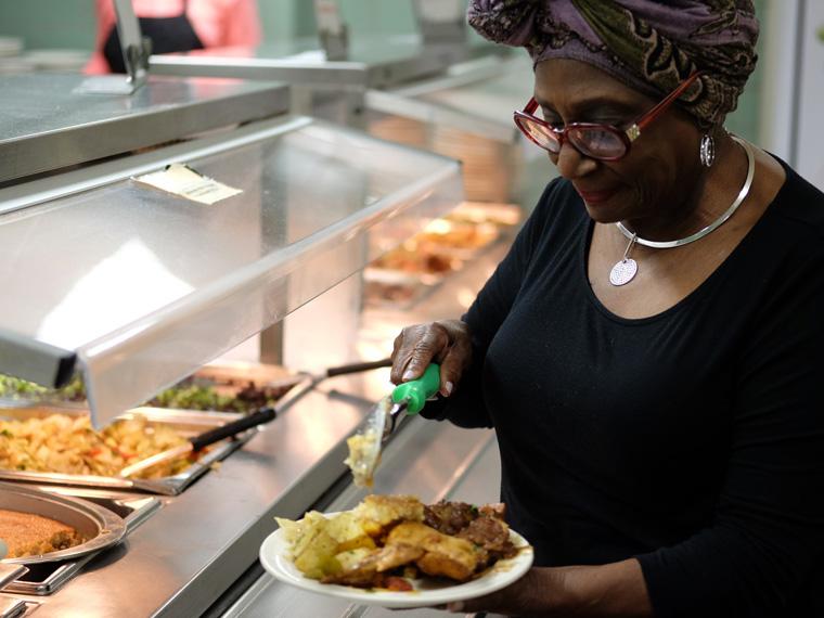 Visiting Chef Vel Scott dishing food at Afrikan Heritage House dining hall. 